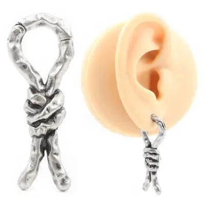 Copper bends and hitches piercing earring for auricle, showing sculptural shape and oiled finish.