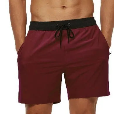 Men's blue drawstring shorts with stitched waistband and zippered pockets, shown for running and fitness use.