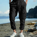 Men's linen cargo trousers with multi-pocket design in army green, black, navy blue, and yellowish brown