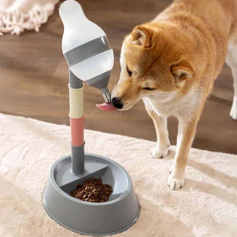Green adjustable pet water dispenser with detachable pole and steel drinking nozzle on a grey floor.
