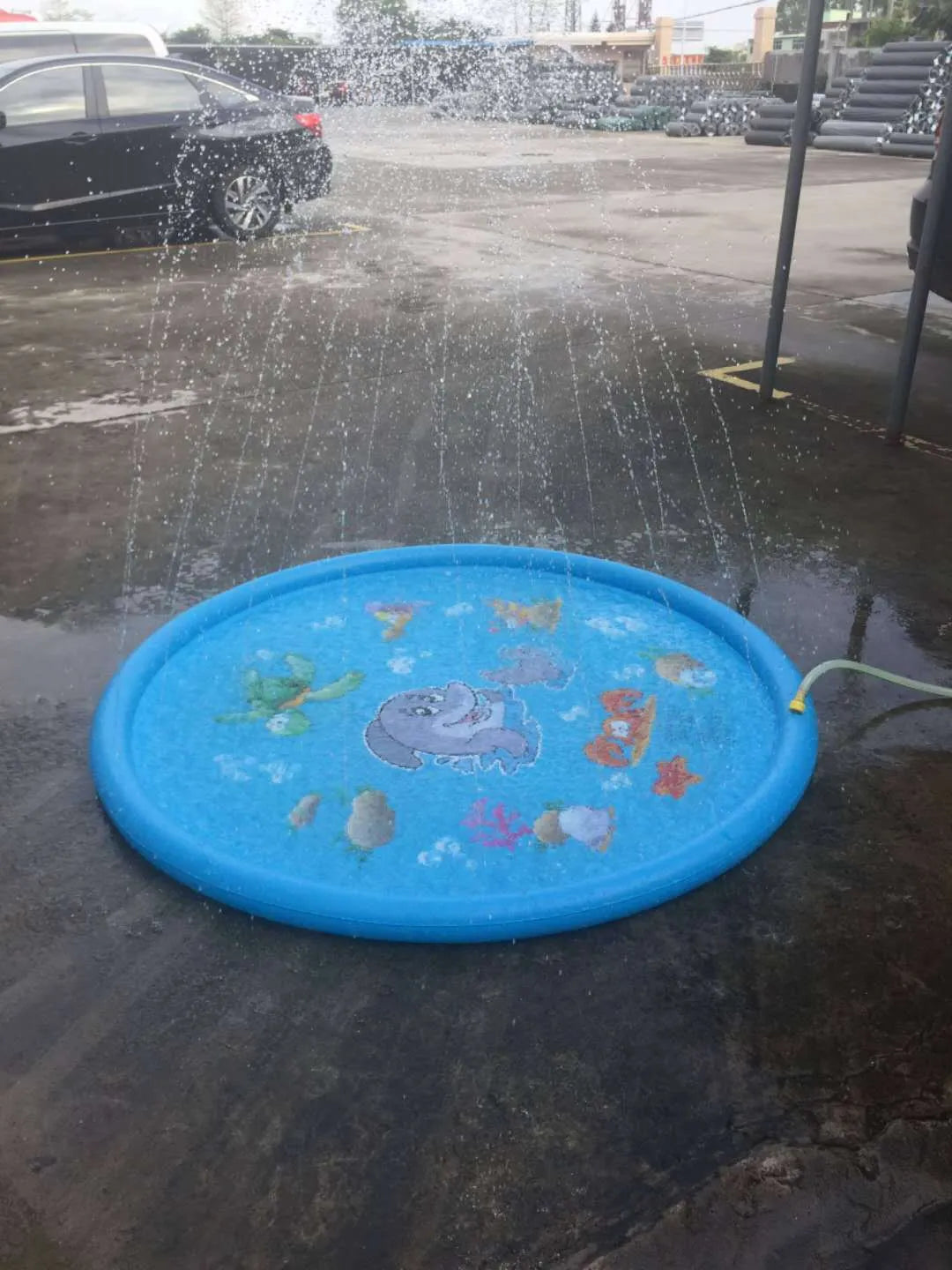 Blue PVC children's water spray mat with marine animal print measuring 100cm by 170cm