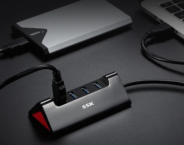 Black USB expansion dock with four USB ports showing compact dimensions