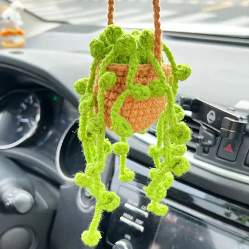Green and white knitted wool car plant decoration with plastic base and hanging rope