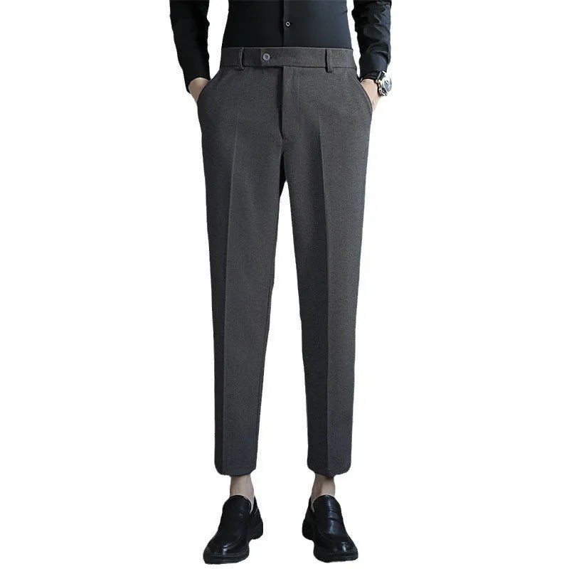 Straight leg brown corduroy trousers for men laid flat, showing texture and elastic waistband.