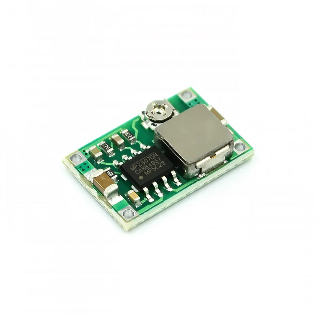 Mini 360 green DC-DC buck converter step down power supply module on white background