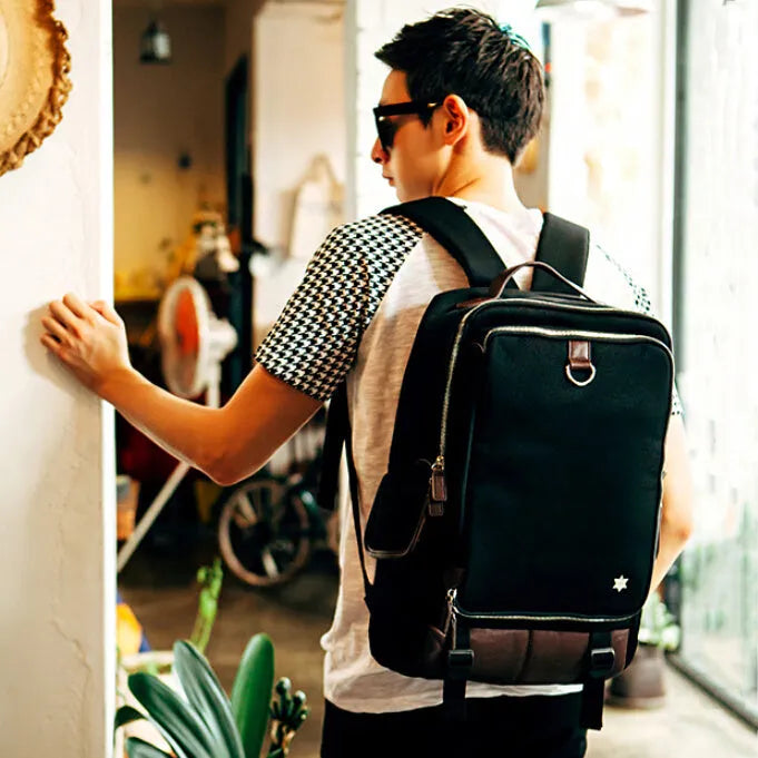 Modern men's Oxford cloth backpack in multiple colours showing large capacity design.