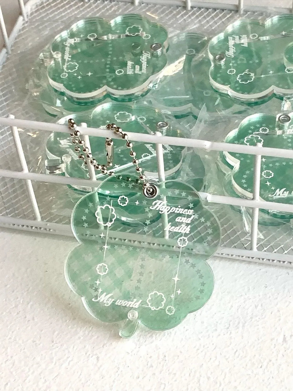 Acrylic four-leaf clover pendant keychain in elegant blue, grass green, and mint green colours.