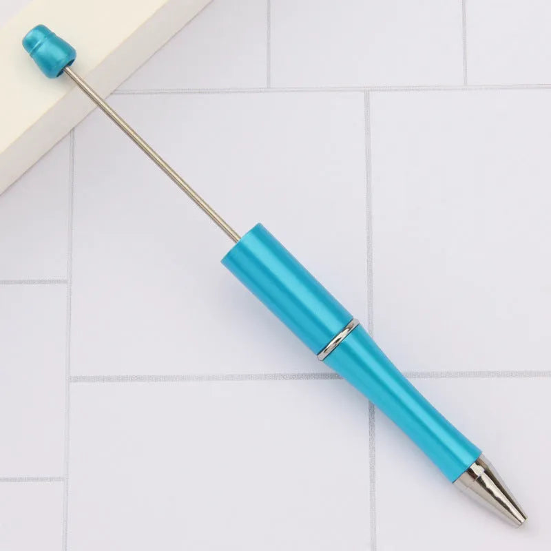 Ballpoint pen with colourful spinning plastic beads on barrel, shown in a gradient purple finish.