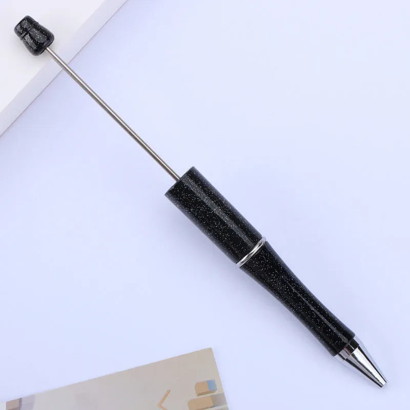 Ballpoint pen with colourful spinning plastic beads on barrel, shown in a gradient purple finish.