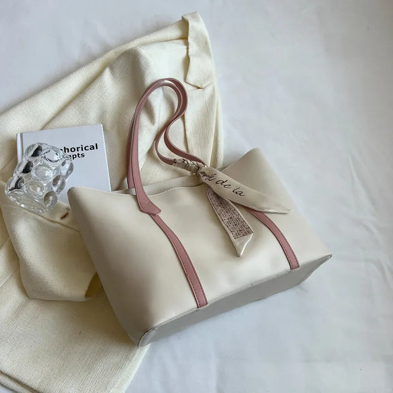 Large soft tote bag in bucket style with crossbody strap and sewing line detailing