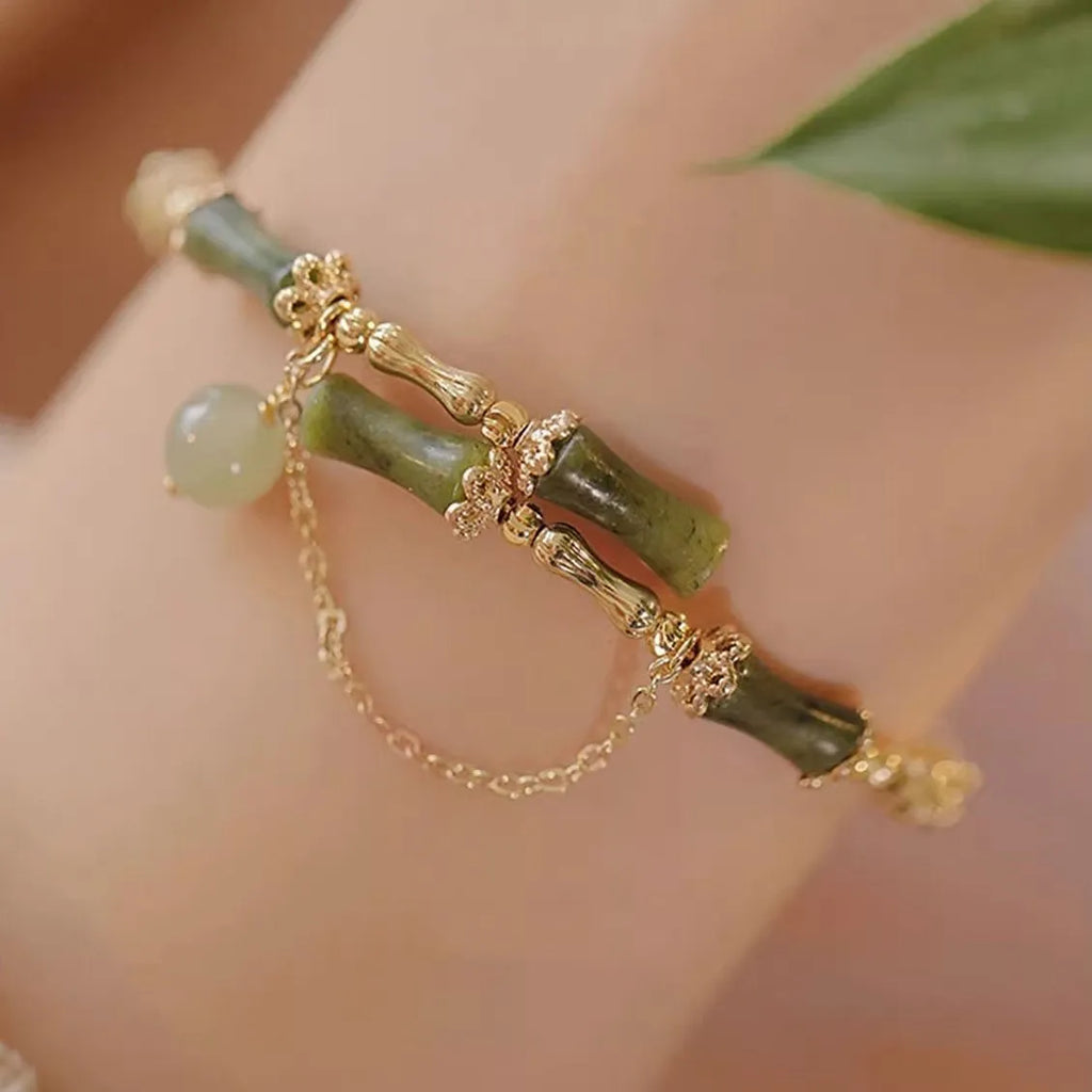 Women's bamboo bracelet with coloured glaze beads in plum wine colour featuring bamboo joint design