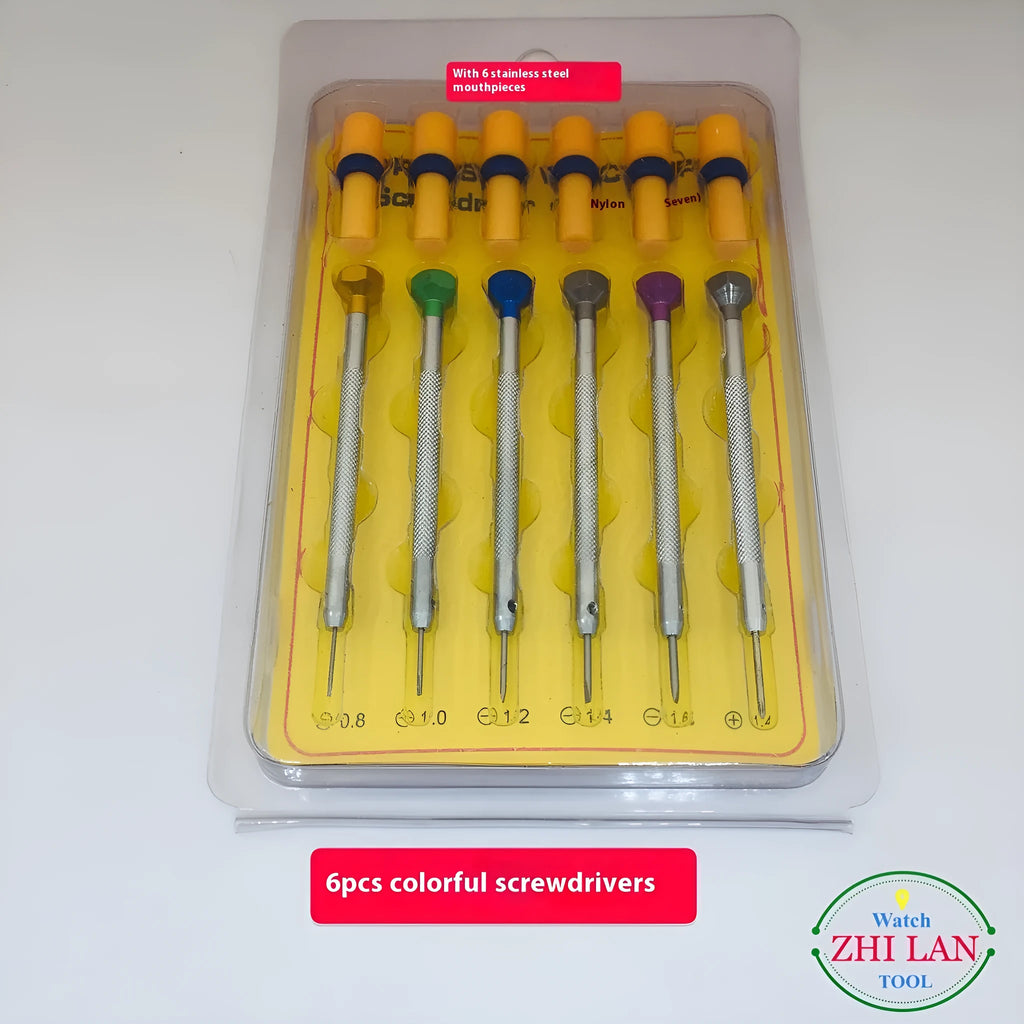 Six colour-coded watch repair screwdrivers with aluminium handles laid out on a surface.