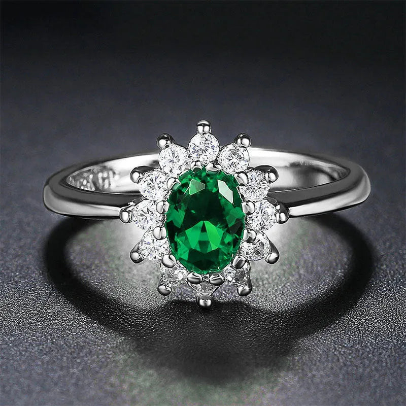 Copper flower-shaped ring with inlaid zirconia available in sapphire blue, green, and pomegranate red colours.