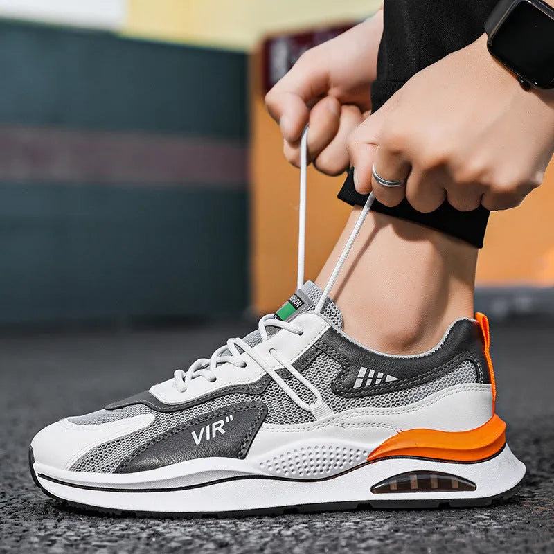 Men's grey mesh running shoes with mid-top height and rounded toe design on white background