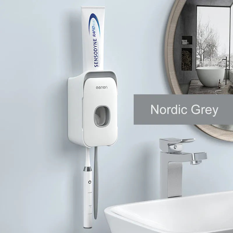A blue automatic toothpaste dispenser mounted on a bathroom wall with a soft-touch button.