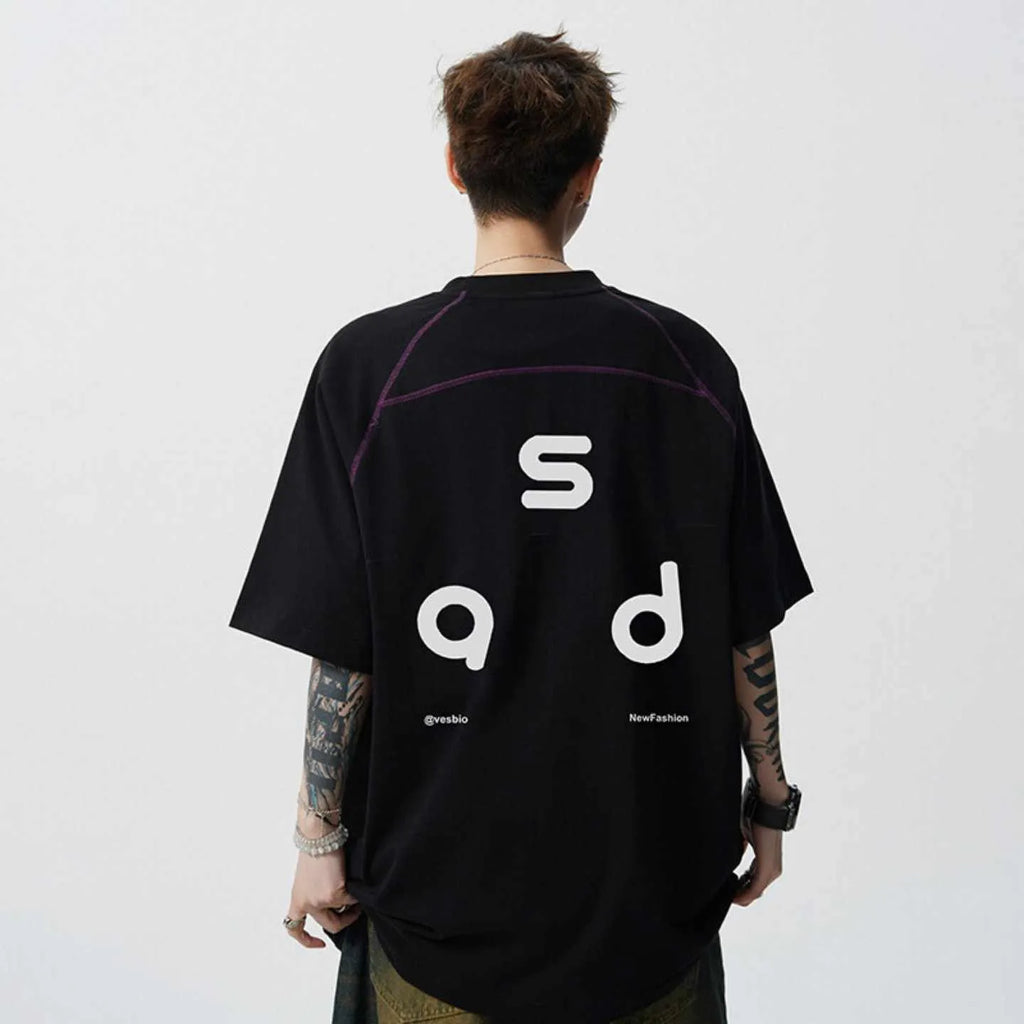 Loose-fitting black cotton T-shirt with a letter print on the chest, showing short sleeves and a round neck.