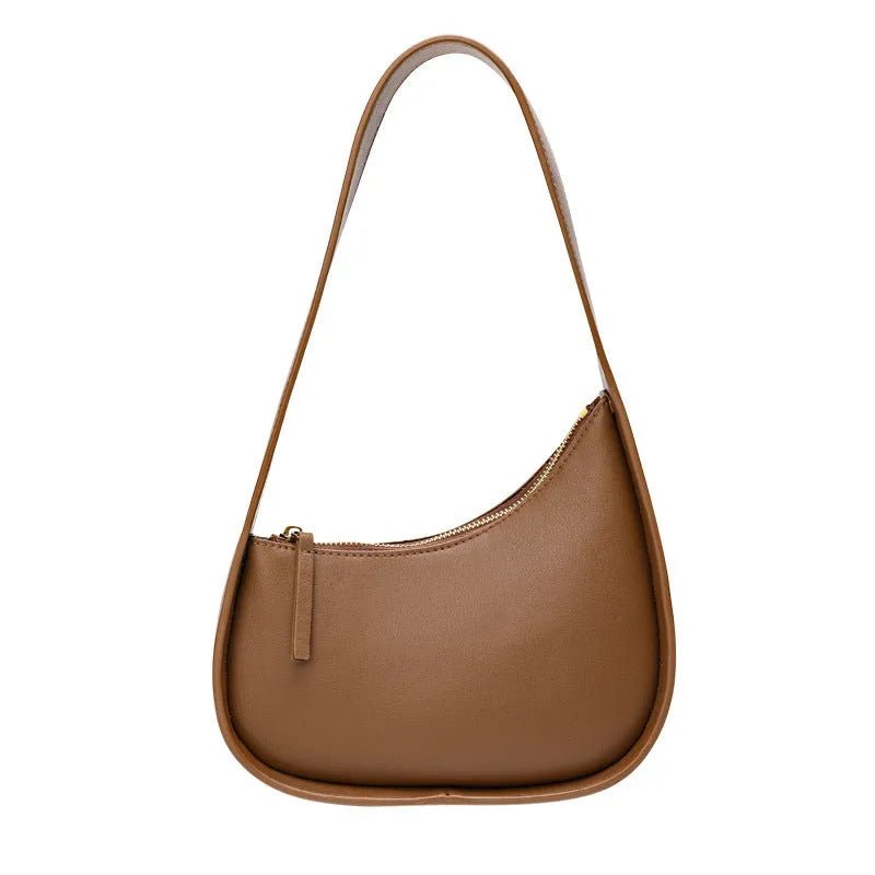 Small half moon leather ladies shoulder bag with wide strap in caramel colour