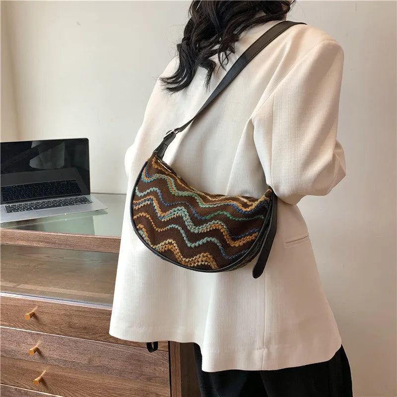 Women's knitted straw woven crossbody bag with single strap in corrugated black or khaki holding phone and files