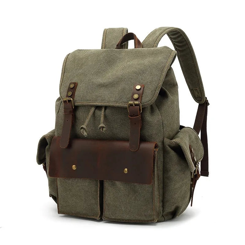 Retro canvas backpack in military green with antique bronze hardware, shown next to a 16-inch laptop.