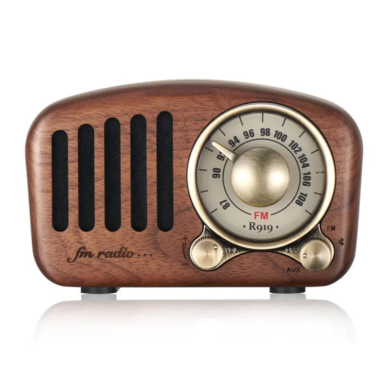 Retro wooden mini Bluetooth speaker in cherry wood finish showing front grille and wooden casing