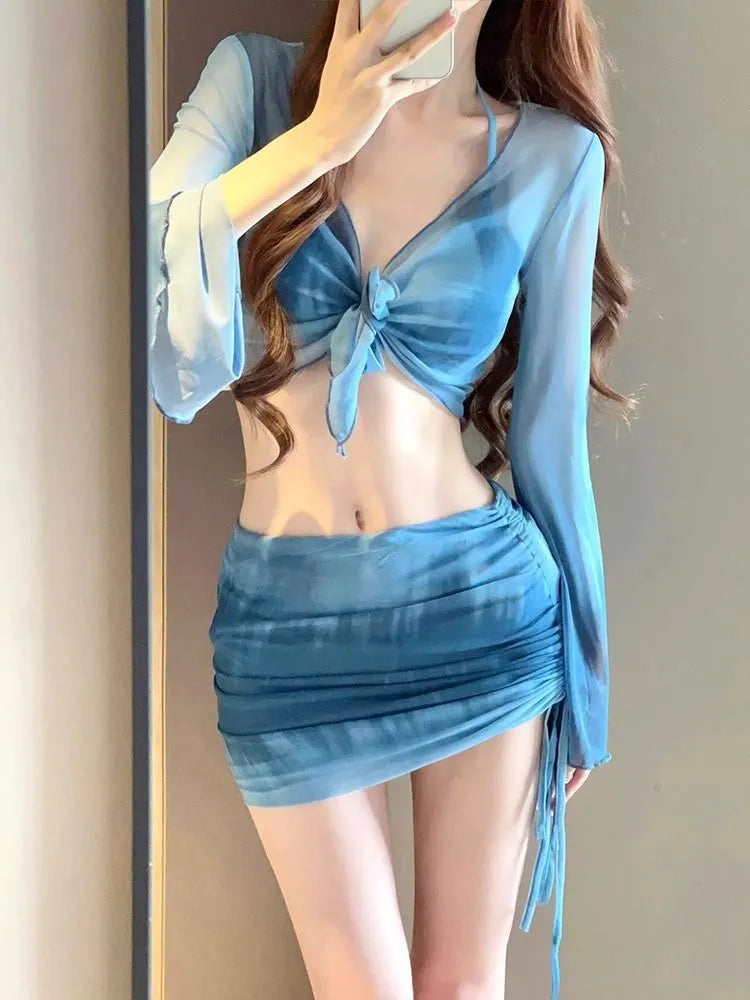 Blue four-piece women's bikini swimsuit set showing shirt, bra, underwear, and skirt with high-waisted design