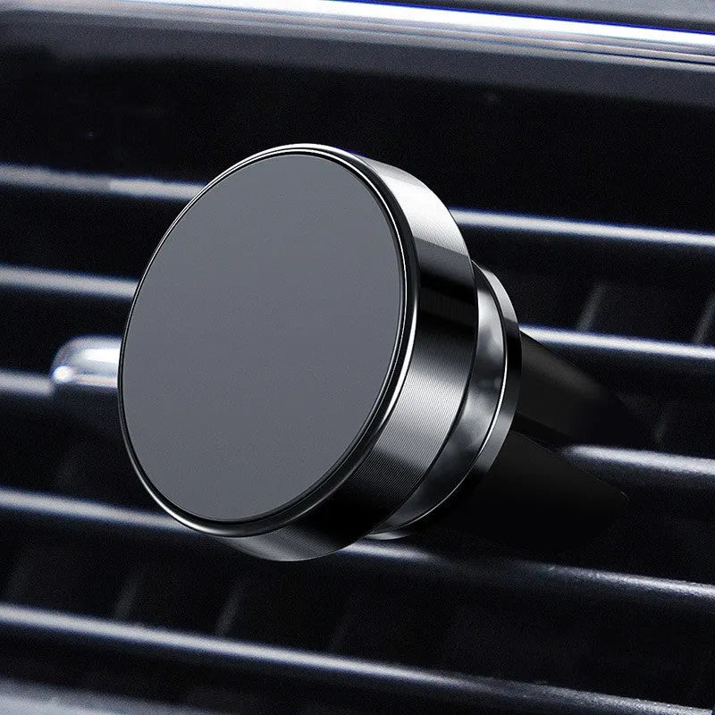 Aluminium alloy magnetic car phone holder in black, showing adhesive paste and snap-type mounting options on a car dashboard.