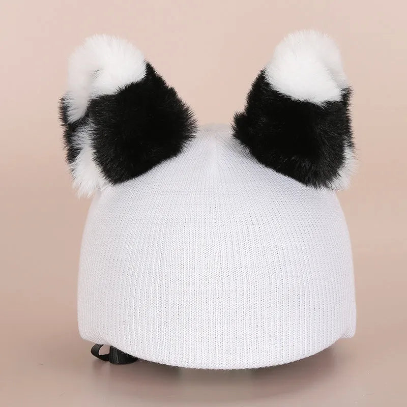 Soft plush ski helmet decoration hat with cartoon design on a blue background.