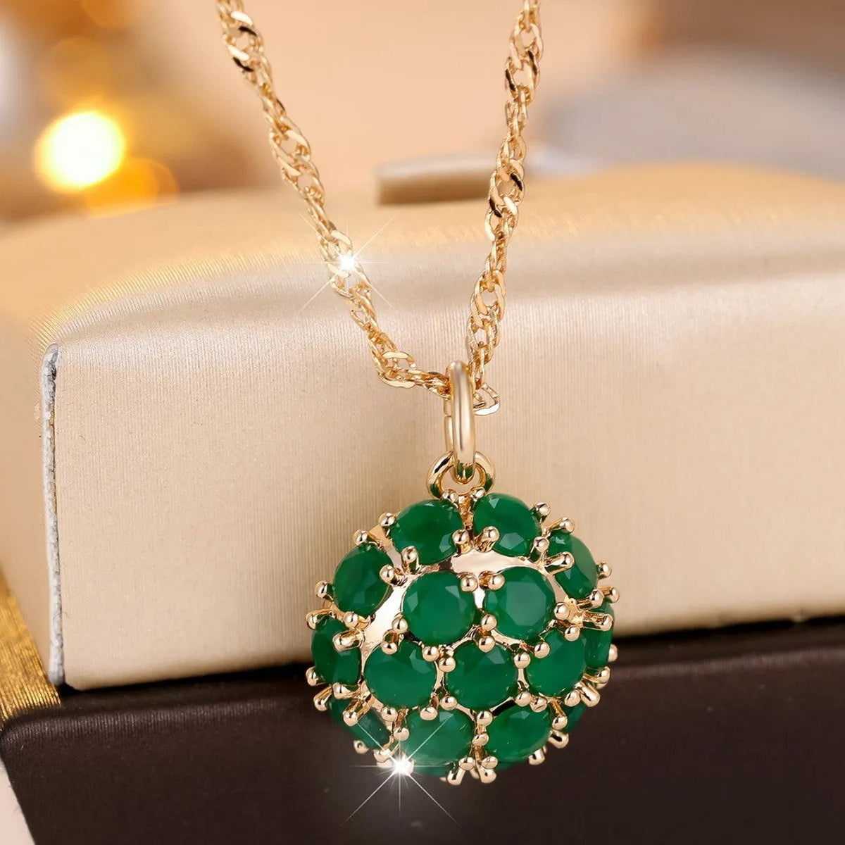 Round green jade pendant with diamond setting on champagne gold chain necklace