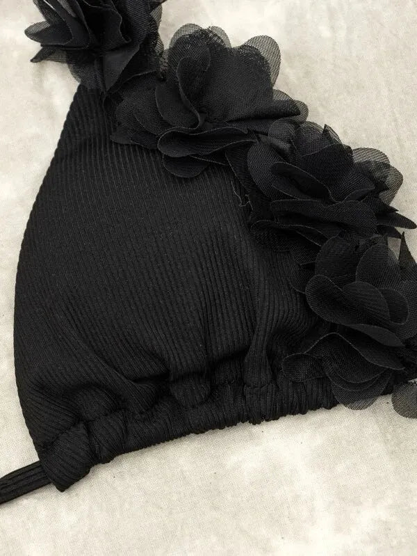 Black women's two-piece bikini swimsuit with gathered design on a mannequin