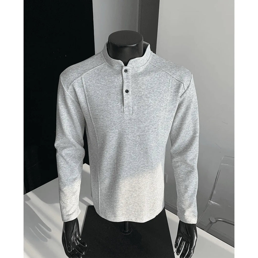 Men's loose fit cotton polo shirt with a stand-up collar and long sleeves in a solid colour.