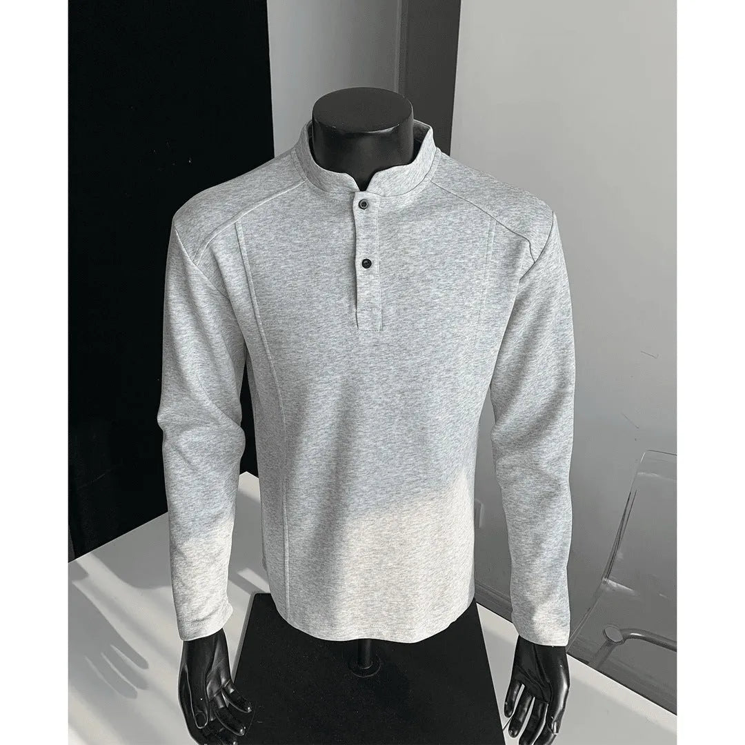 Men's loose fit cotton polo shirt with a stand-up collar and long sleeves in a solid colour.