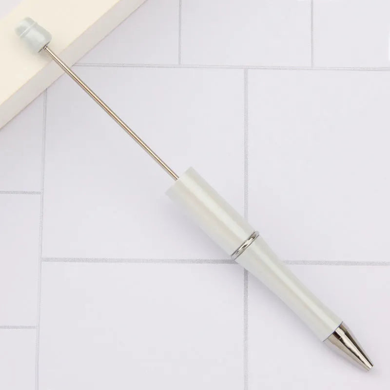 Ballpoint pen with colourful spinning plastic beads on barrel, shown in a gradient purple finish.
