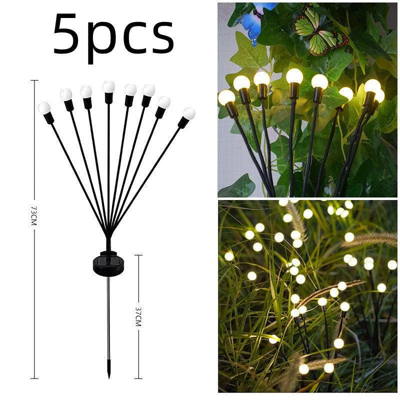 Solar-powered LED firefly ground spike light with multiple heads inserted along a garden path.