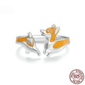 Cartoon-style silver corgi dog ring on a plain background.