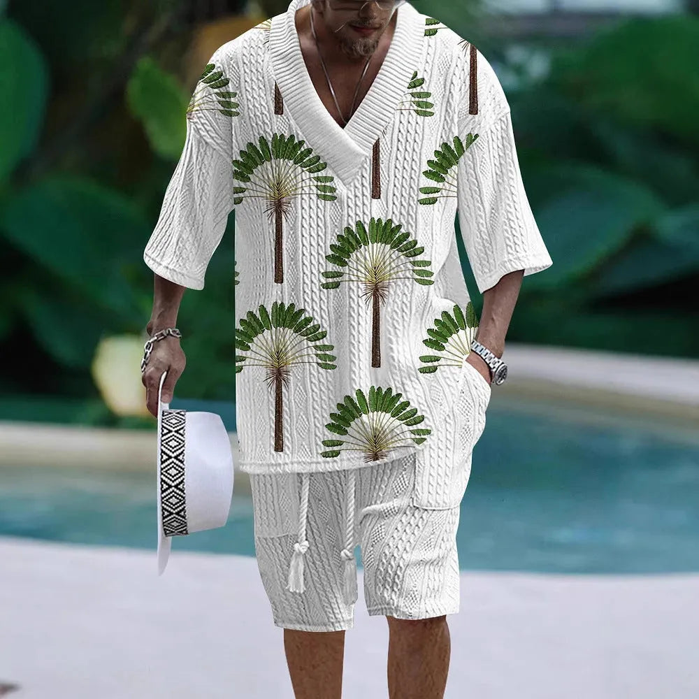 Man wearing a loose light blue short sleeve casual suit top with matching shorts.