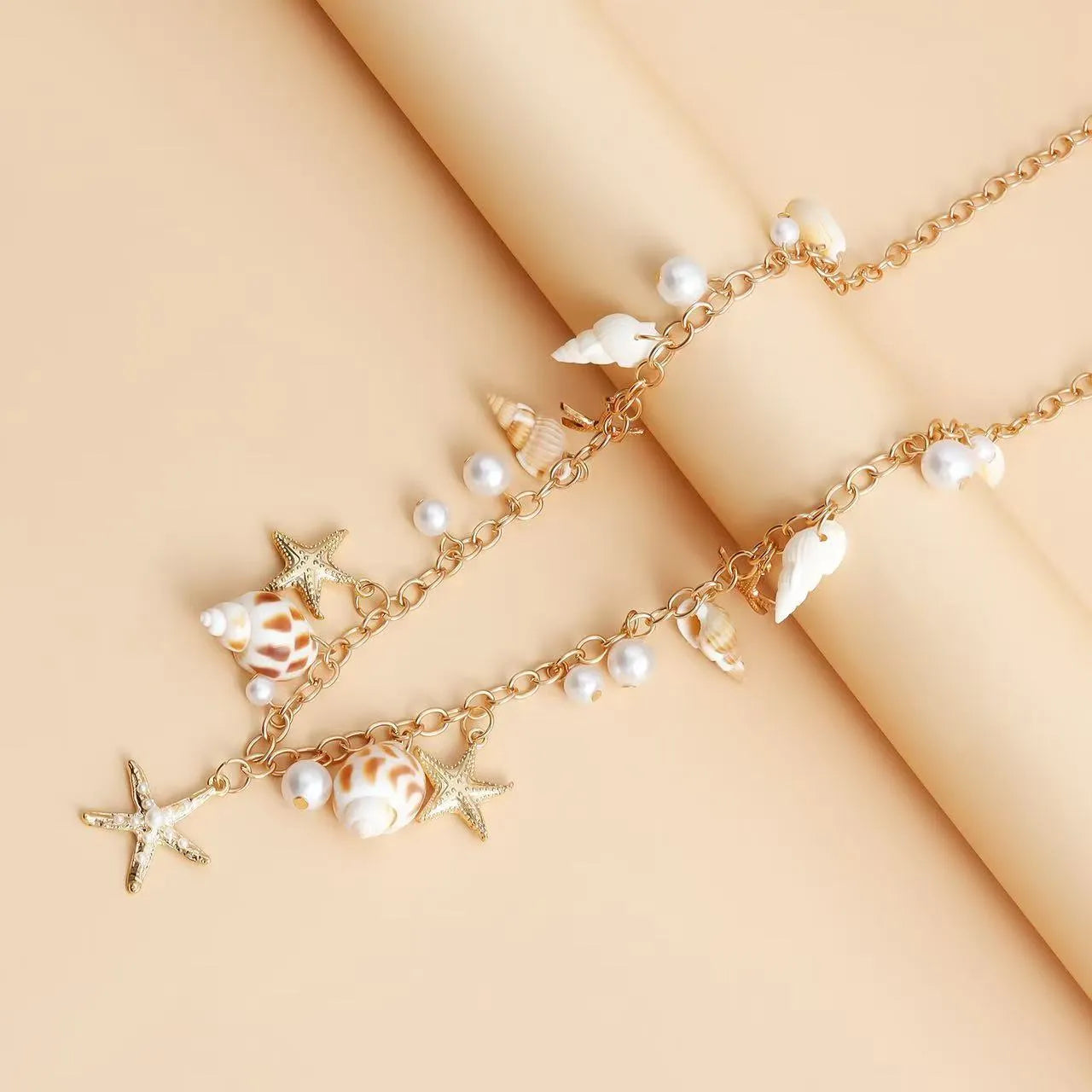 Women's alloy waist chain and matching bracelet set with a star charm on a model.