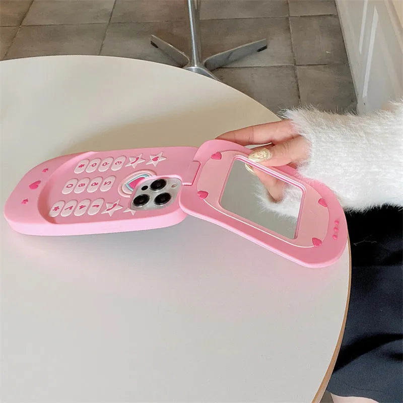 Light pink silicone flip phone case with built-in mirror for iPhone, showing cute cartoon design.