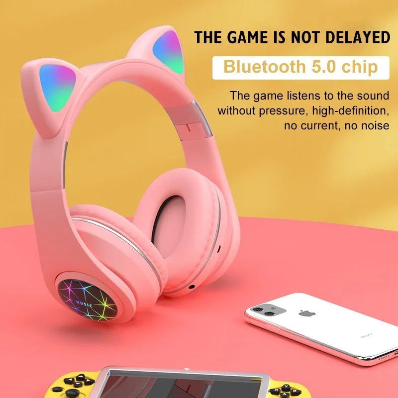 Colourful cat ear style wireless Bluetooth sports headset with a headband, shown in pink.