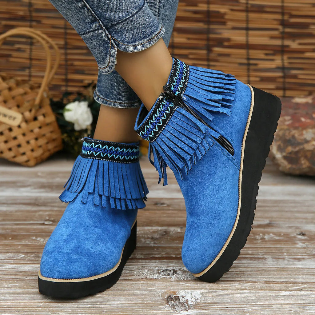 Women's dark brown suede ankle boots with thick platform wedge sole, side zip, and tassel detail.
