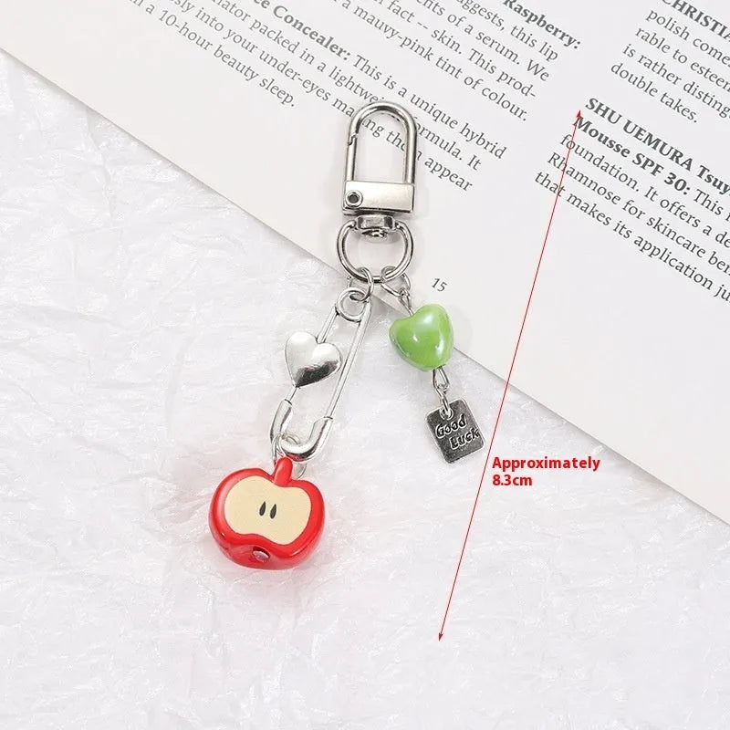 Plastic resin iPhone charm bag pendant keychain with fruit patterns including apple core and strawberry designs