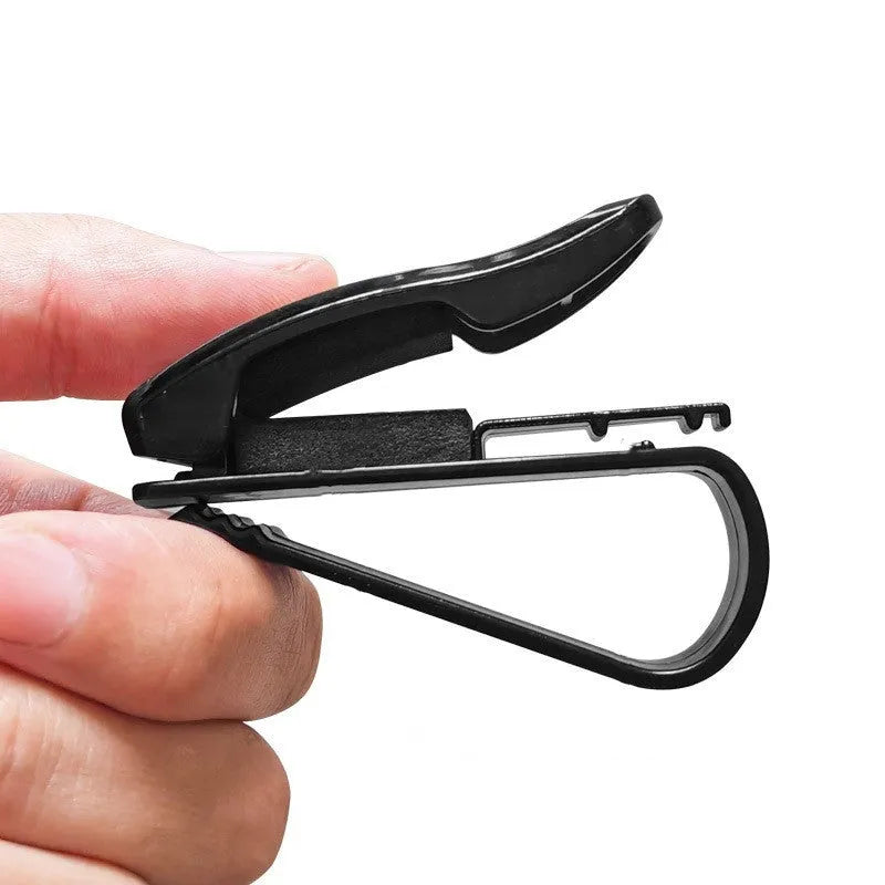 Black plastic multifunctional clip for car sunshade holding sunglasses and cards.