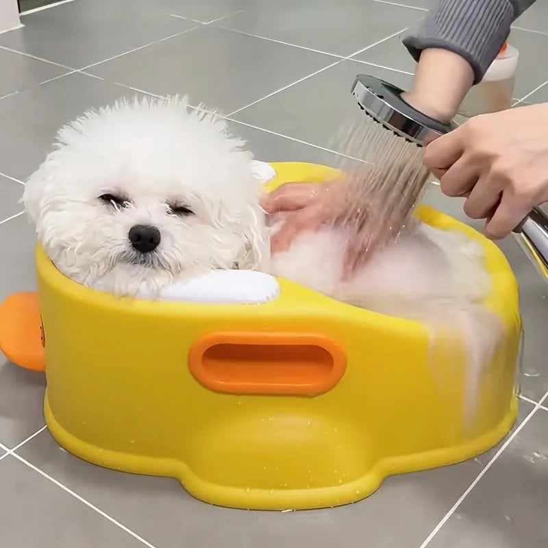 Blue PVC duck-shaped bathtub for washing dogs and cats on grass