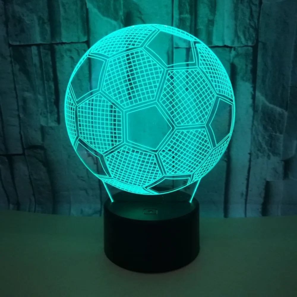 3D football-shaped acrylic night light displaying blue LED colour on a black ABS base.