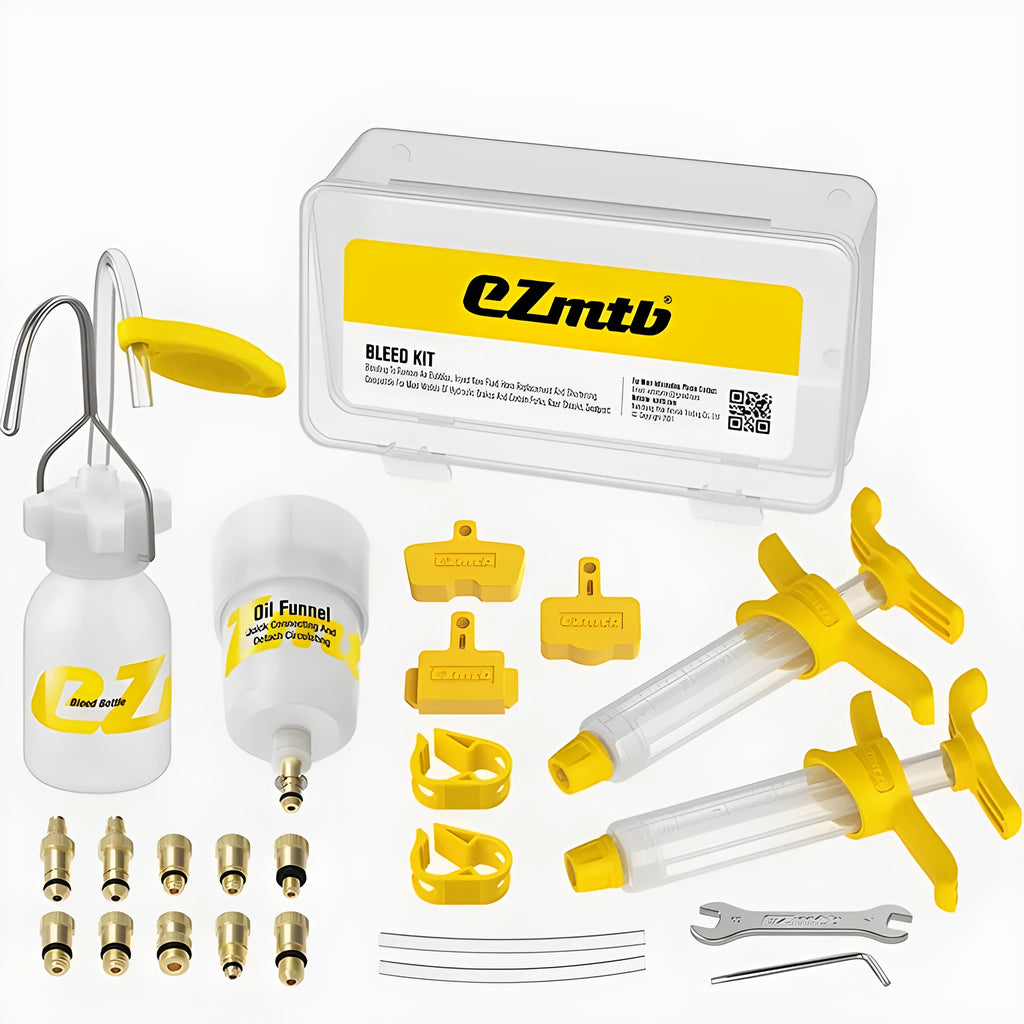 EZmtb bicycle hydraulic disc brake bleed kit with syringes, adapters, and tools on a workbench