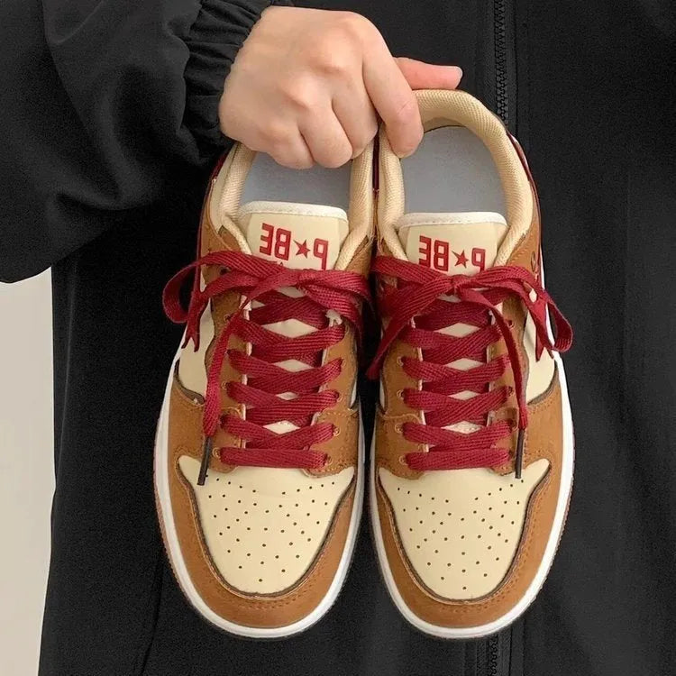 Brown women's low-top platform sneakers with sequin trim and round toe, shown from the side.