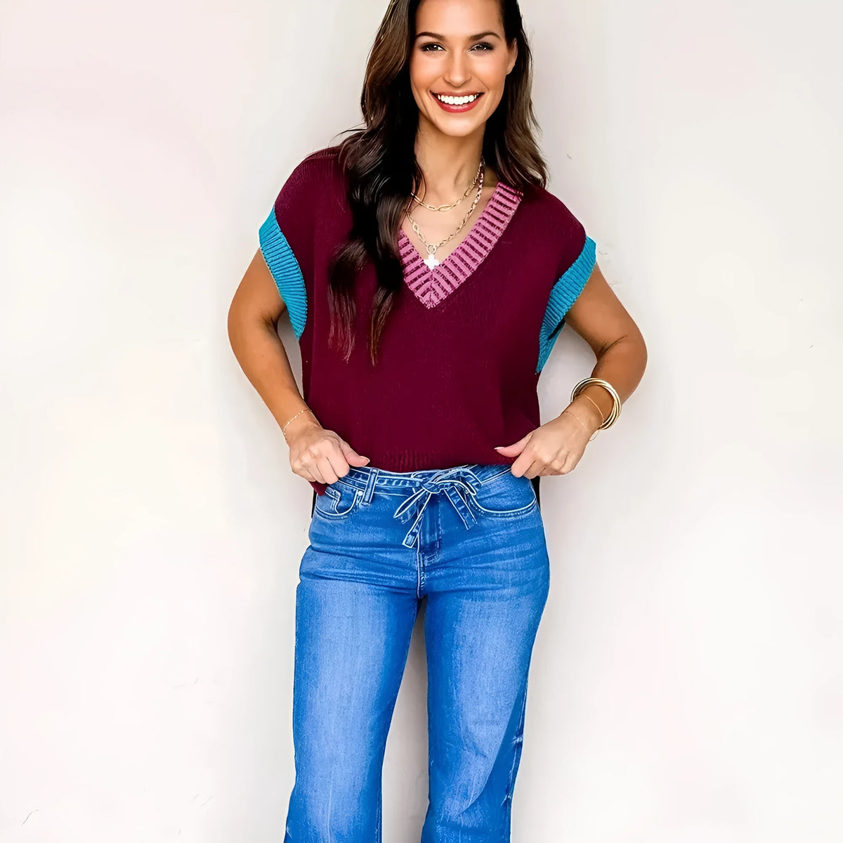 Burgundy loose-fit V-neck sweater with contrast trim on the cuffed short sleeves.