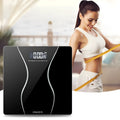 Black electronic bathroom scale on a floor, showing digital display and low-profile platform design.