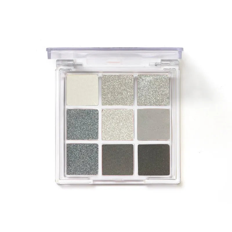 INS-style nine-color eyeshadow palette open, showing white, silver, black, and iron grey pressed powder shades.