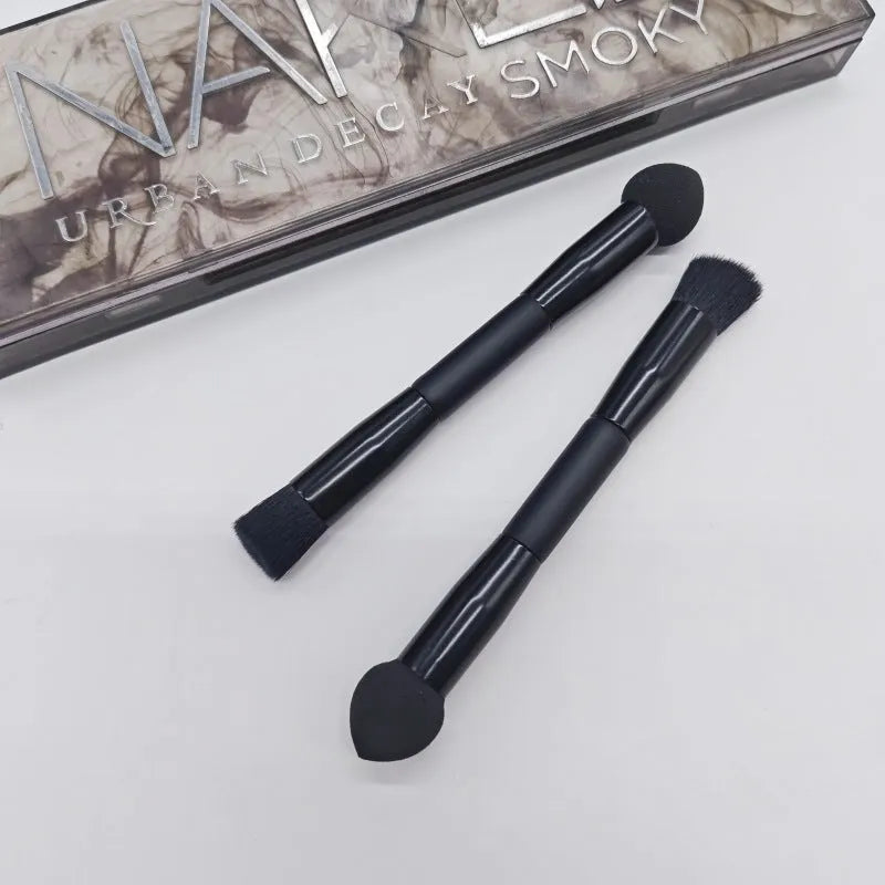 Elegant black double-headed makeup brush with a miter sponge and concealer brush on a wooden handle