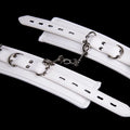 White PU sponge bondage set showing handcuffs, ankle cuffs, and a neck restraint collar.